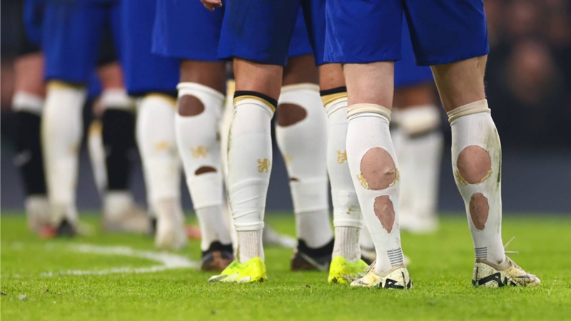 Why do footballers cut holes in their socks during matches?