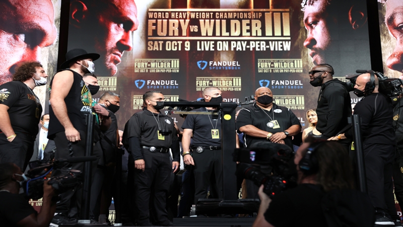 Tyson Fury, Deontay Wilder come in at career-high weight; have heated staredown