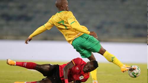 Emmanuel Okwi of Uganda challenged by Nkosinathi Sibisi of South Africa