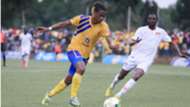 John Revita (L) dribbles past an opponent of KCCA FC vs Kyetume FC.