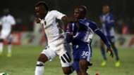 Mthokozisi Dube of Orlando Pirates holds off Mxolisi Kunene