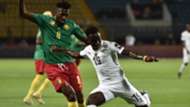 Ghana's midfielder Samuel Owusu prepares to take a shot as he is marked by Cameroon's midfielder Andre-Frank Zambo Anguissa during the 2019 Africa Cup of Nations
