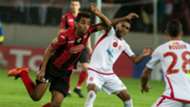 Wydad Casablanca's Mohammed Ounnajem (white) vies for the ball with the USM Alger's Mohamed Benkhemassa