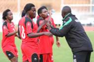 Harambee Starlets coach David Ouma issues instructions to the players at the break