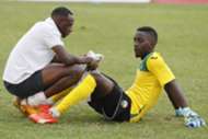 Harambee Stars goalkeeper Arnold Origi is consoled by keeper trainer Mathews Ottamax