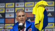 Carlos Queiroz holds up a Colombian jersey as he speaks during a press conference in Bogota 07022019